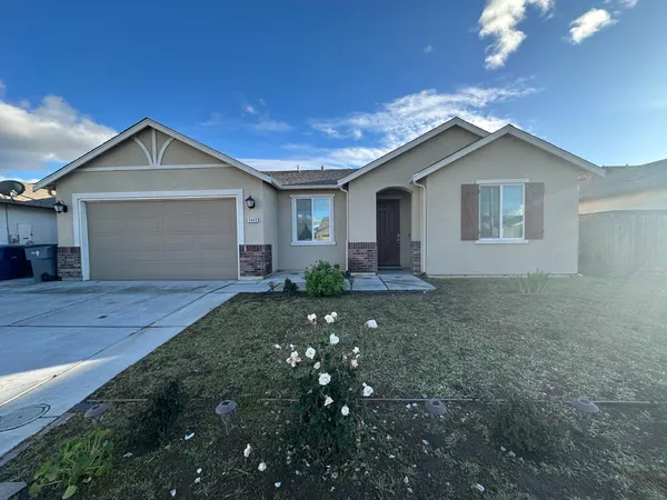 an empty room with closet and a chandelier fan