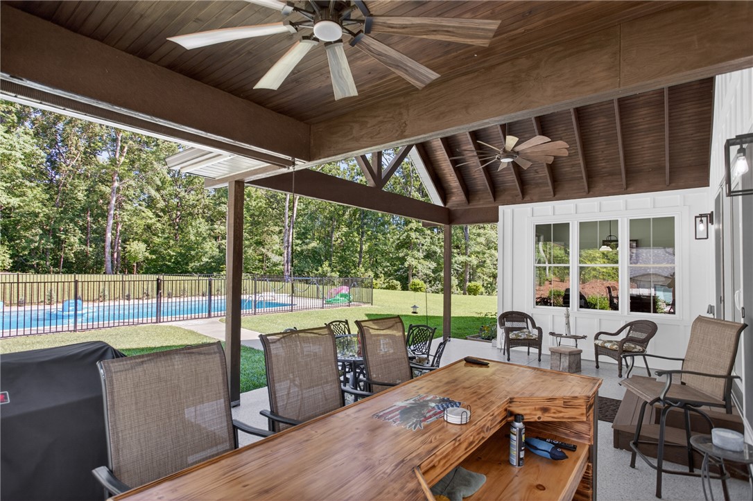 921 Falling Waters Lane Seneca, SC 29672 - Photo 37 of 46 An inviting covered patio offers ample space for entertaining by the in-ground pool.