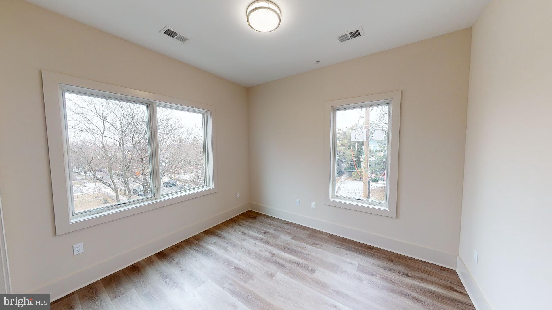 917 Sheridan Street Northwest, Unit 301 Washington, DC 20011 - Photo 4 of 8 a view of an empty room with wooden floor and a window