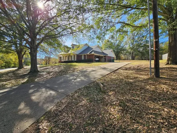 a wooden house with trees in front of it