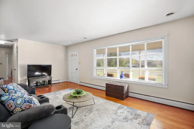 a view of a backyard with plants and wooden fence