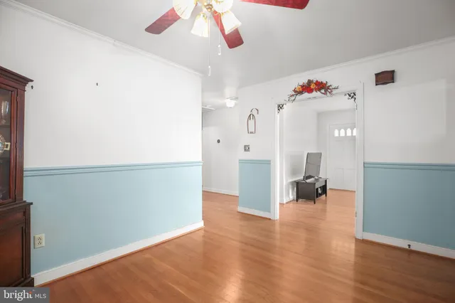 a view of a small yard in front of a house with large tree