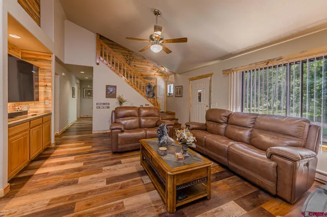 a living room with furniture and a wooden floor