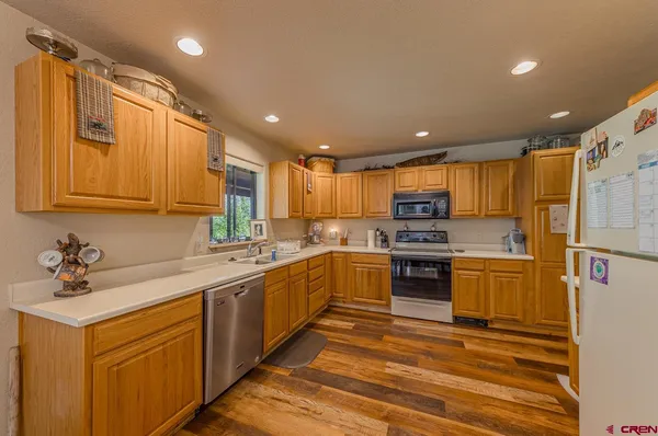a kitchen with a sink stainless steel appliances and cabinets