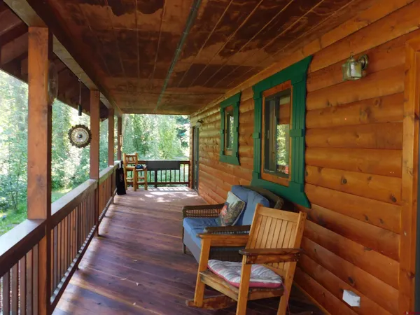 a view of two chairs in the balcony