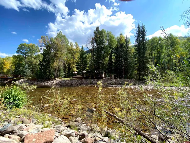 a view of swimming pool with a yard and green space