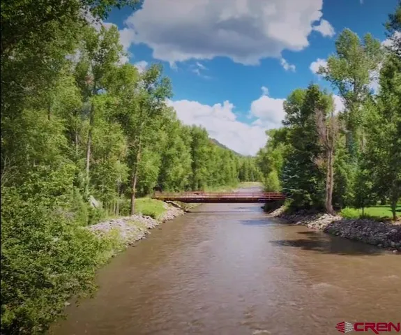 a view of a street with trees on both side of it