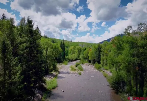 a view of a pathway with a big yard