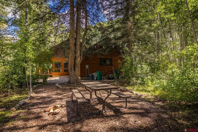 a view of backyard with trees and seating area