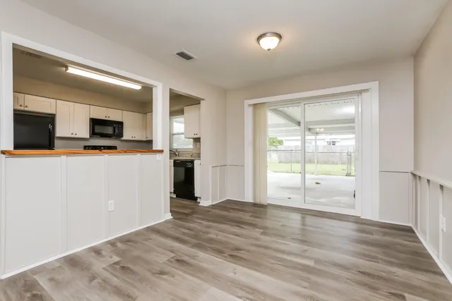 a view of a kitchen with wooden floor and a sink