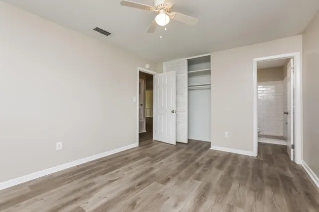 a view of an empty room with wooden floor