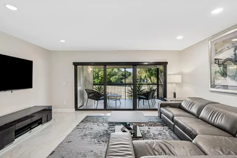 a en suite bathroom with a granite countertop sink and a mirror