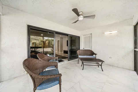 a view of a balcony with a small yard