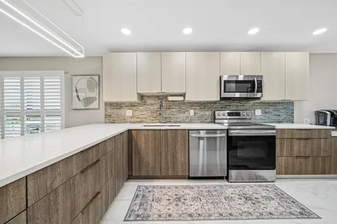 a kitchen with stainless steel appliances a refrigerator and a stove top oven