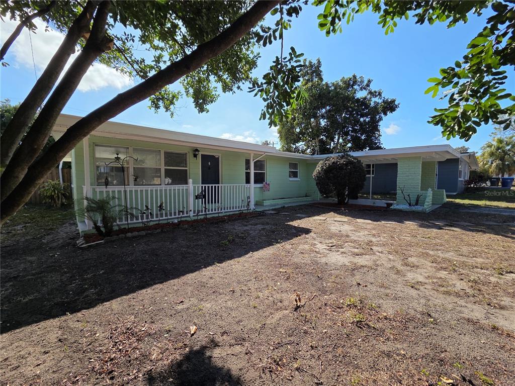 a front view of house with yard and green space