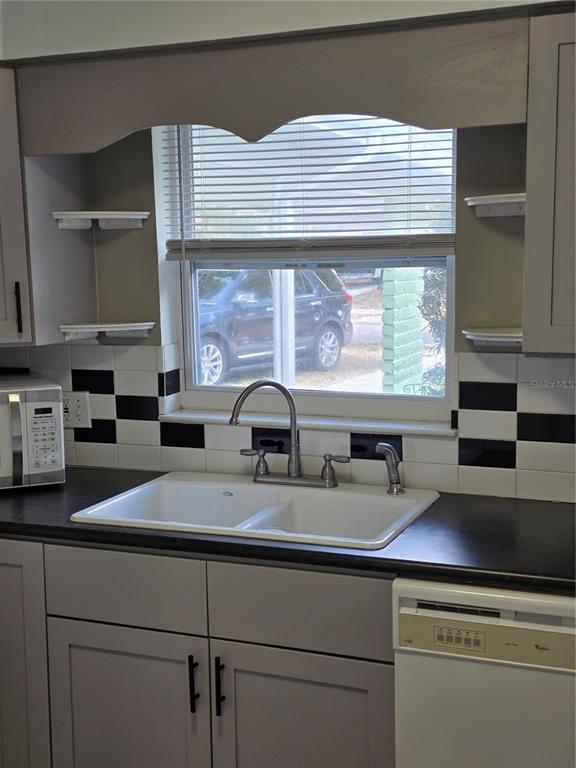 298 11th Avenue Southwest Largo, FL 33770 - Photo 11 of 34 a kitchen with a sink and cabinets