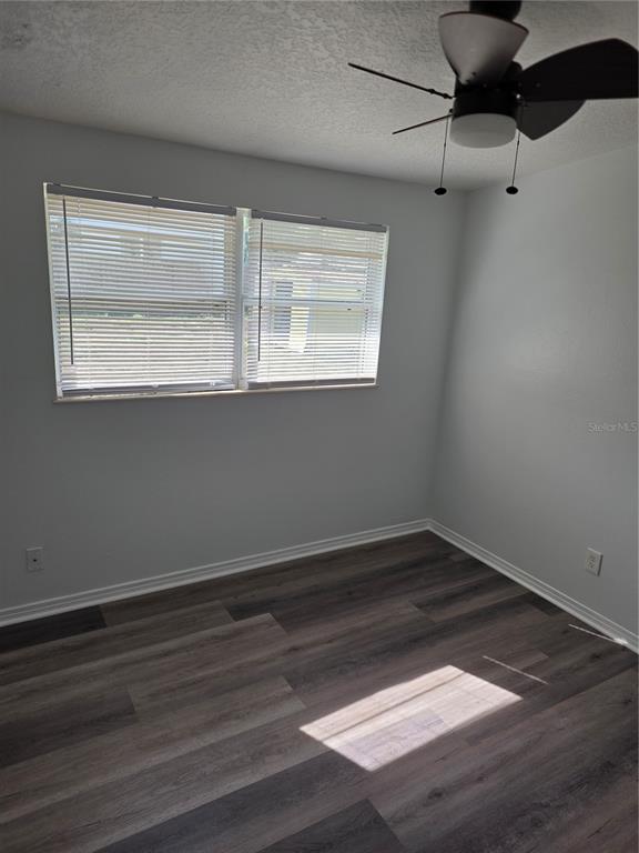 298 11th Avenue Southwest Largo, FL 33770 - Photo 18 of 34 a view of an empty room with wooden floor and a window