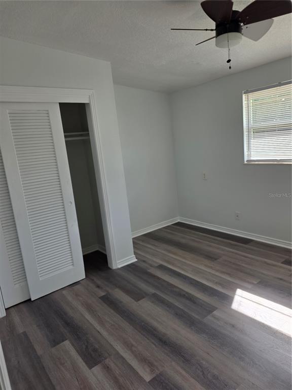 298 11th Avenue Southwest Largo, FL 33770 - Photo 19 of 34 an empty room with wooden floor and windows