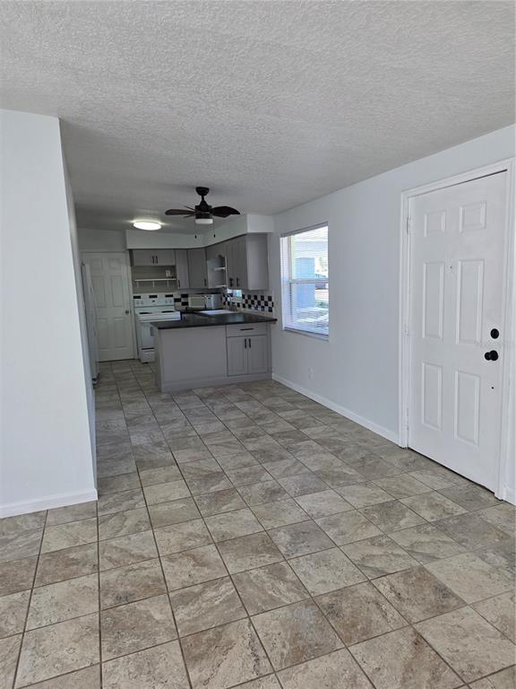 298 11th Avenue Southwest Largo, FL 33770 - Photo 24 of 34 a kitchen with stainless steel appliances a sink stove and cabinets