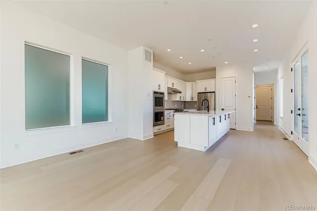 a view of kitchen with kitchen island and stainless steel appliances