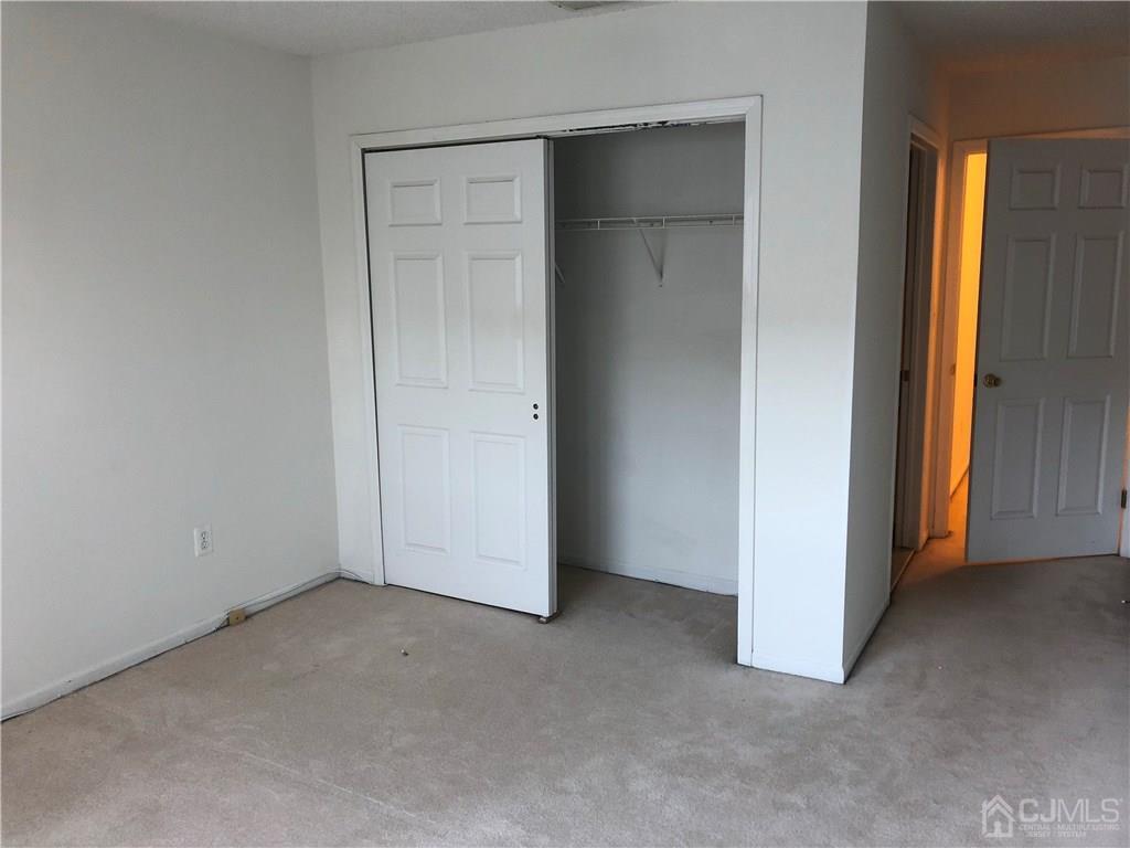 22 Prestwick Way, Unit 22 Edison, NJ 08820 - Photo 4 of 8 an empty room with windows and closet