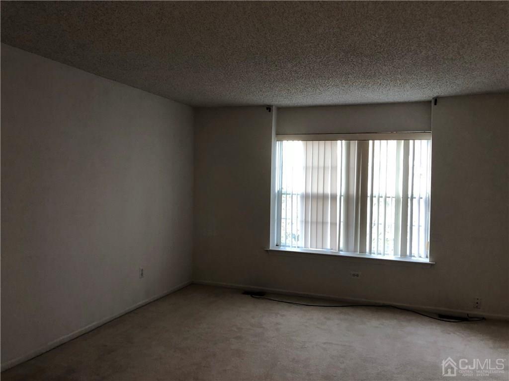 22 Prestwick Way, Unit 22 Edison, NJ 08820 - Photo 5 of 8 an empty room with a window