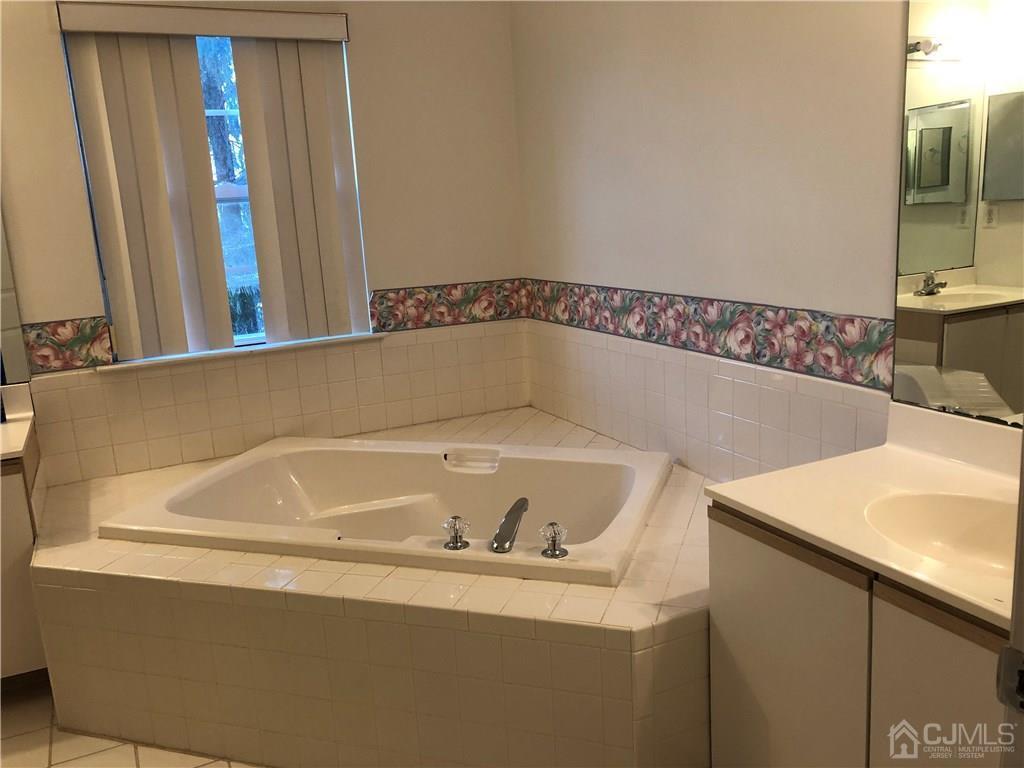 22 Prestwick Way, Unit 22 Edison, NJ 08820 - Photo 6 of 8 a bathroom with a bathtub and a sink