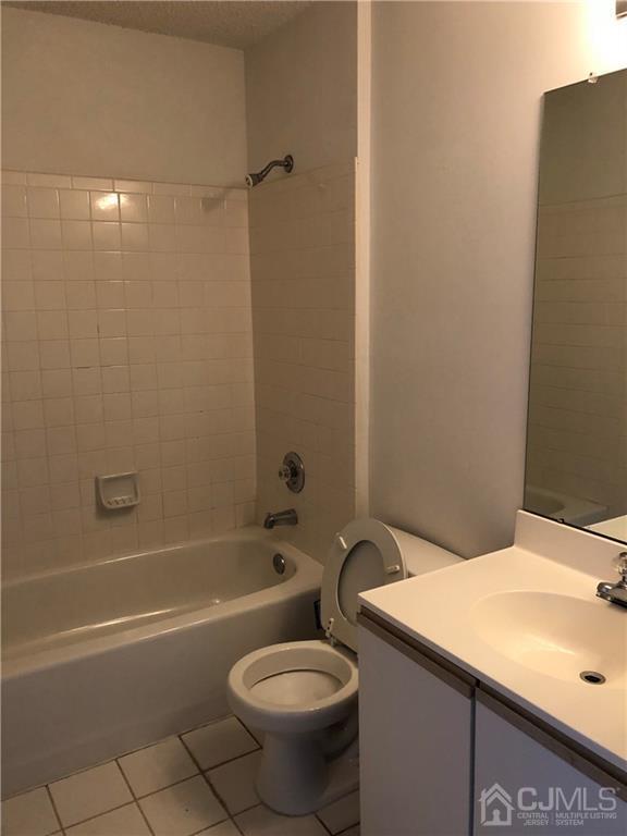 22 Prestwick Way, Unit 22 Edison, NJ 08820 - Photo 7 of 8 a bathroom with a sink a toilet and shower