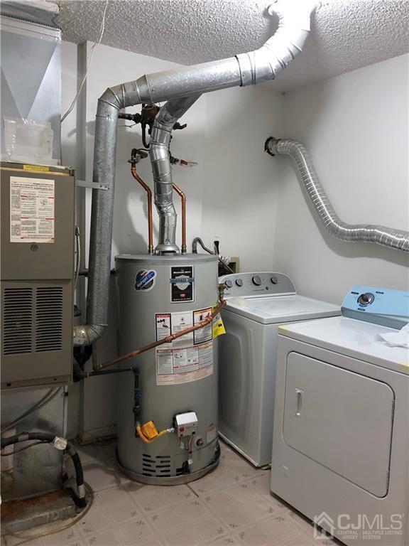 22 Prestwick Way, Unit 22 Edison, NJ 08820 - Photo 8 of 8 a utility room with dryer and washer