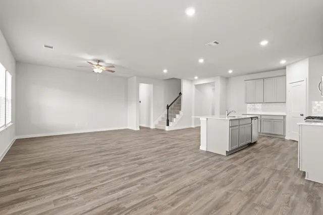 a view of kitchen with kitchen island microwave and wooden floor
