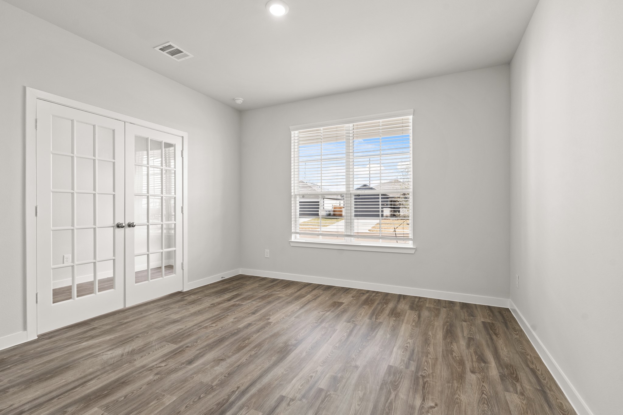 117 Bayou Bend Angleton, TX 77515 - Photo 9 of 28 an empty room with wooden floor and windows