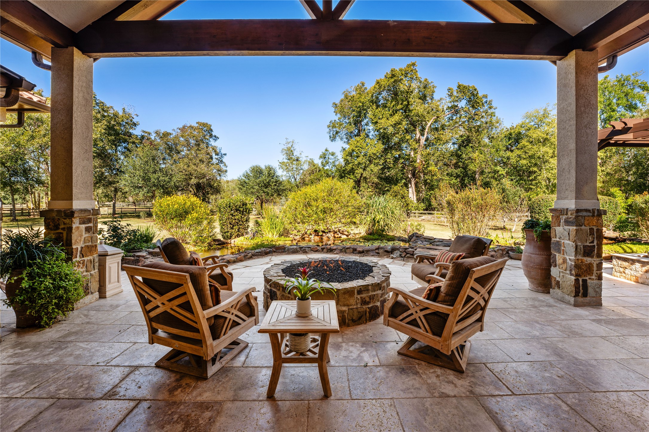 a view of a patio with table and chairs and potted plants