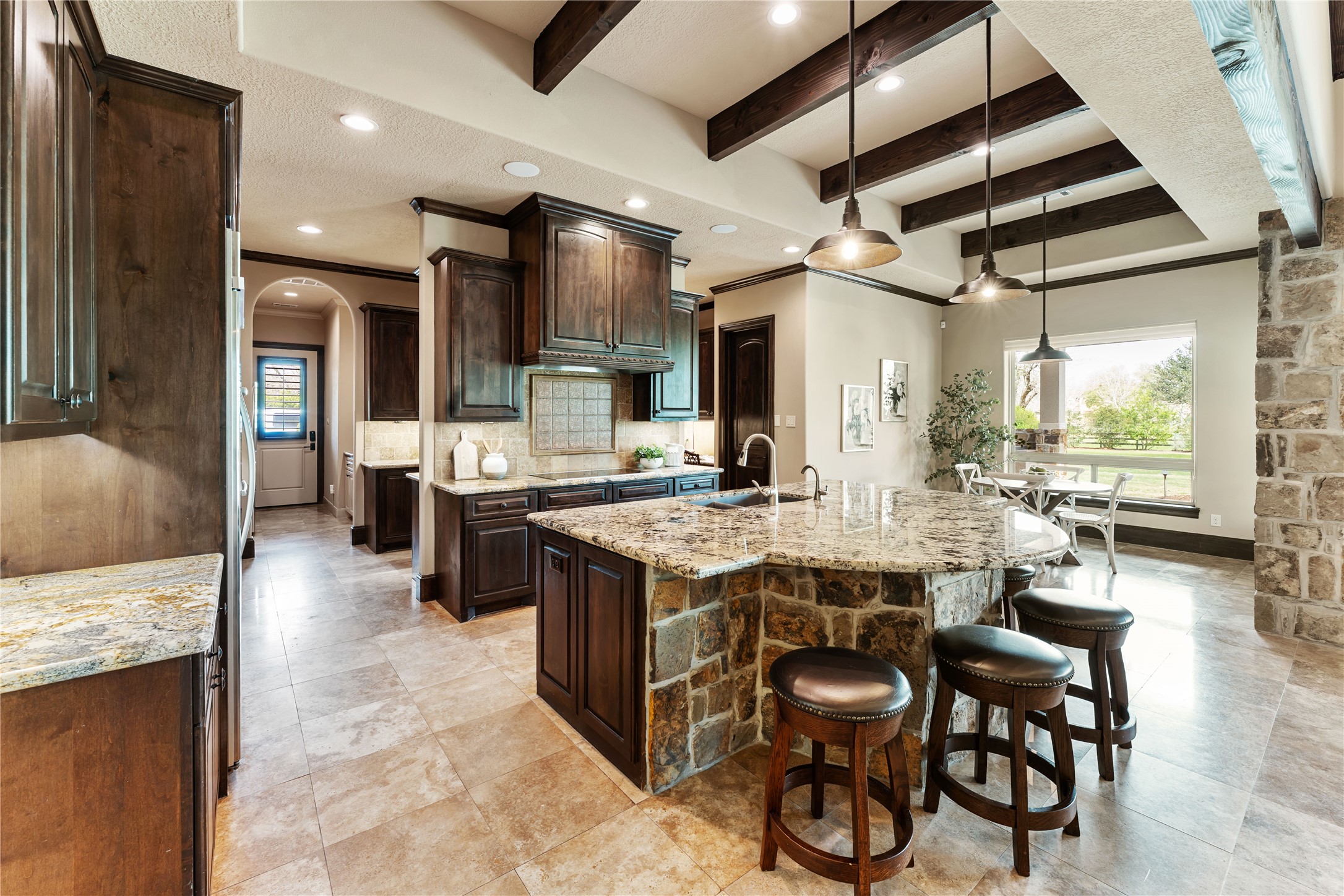 4727 Sugar Maple Court Fulshear, TX 77441 - Photo 11 of 50 a kitchen with kitchen island granite countertop lots of counter top space and stainless steel appliances
