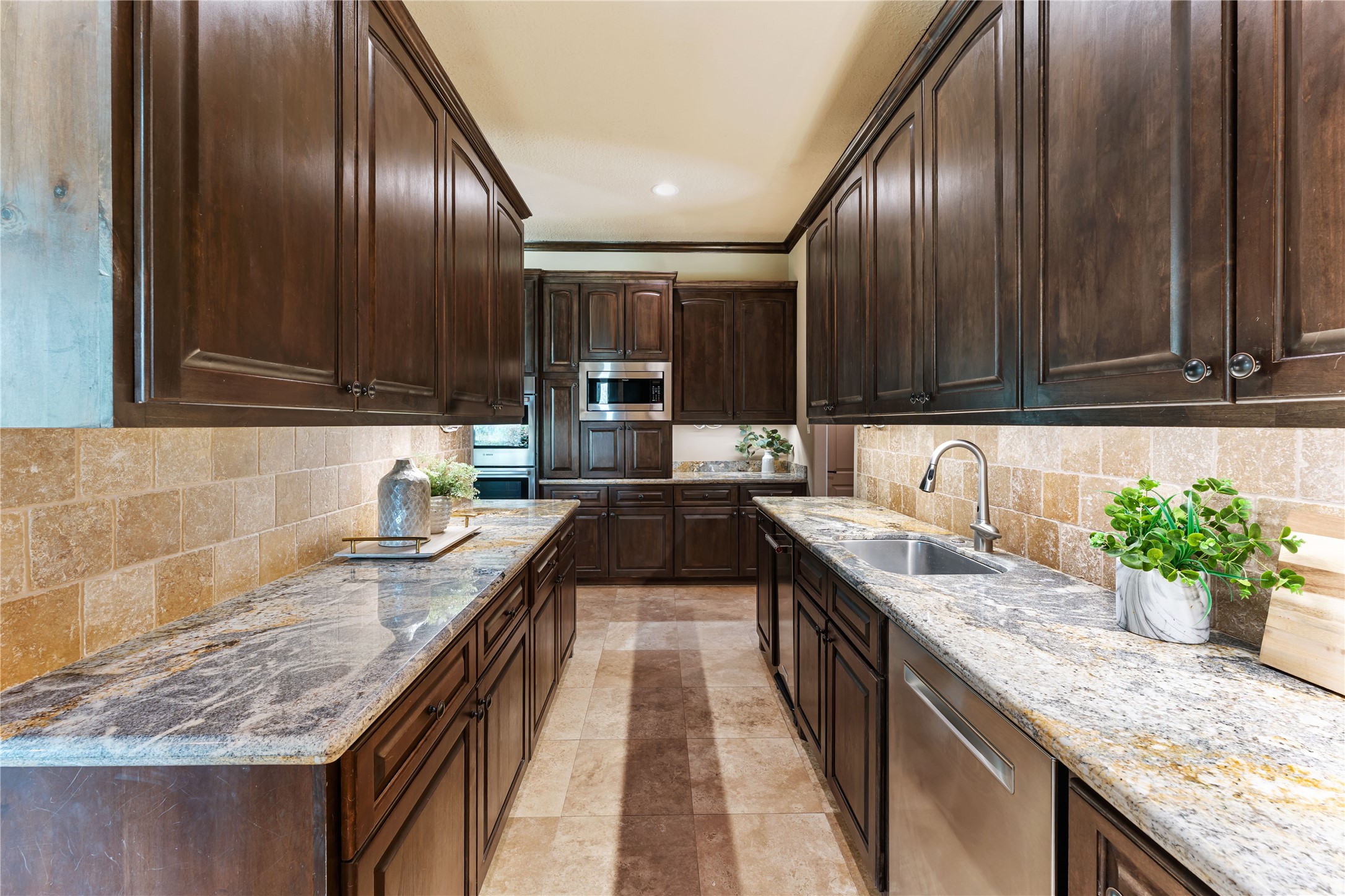 4727 Sugar Maple Court Fulshear, TX 77441 - Photo 14 of 50 a kitchen with granite countertop stainless steel appliances a sink stove and cabinets
