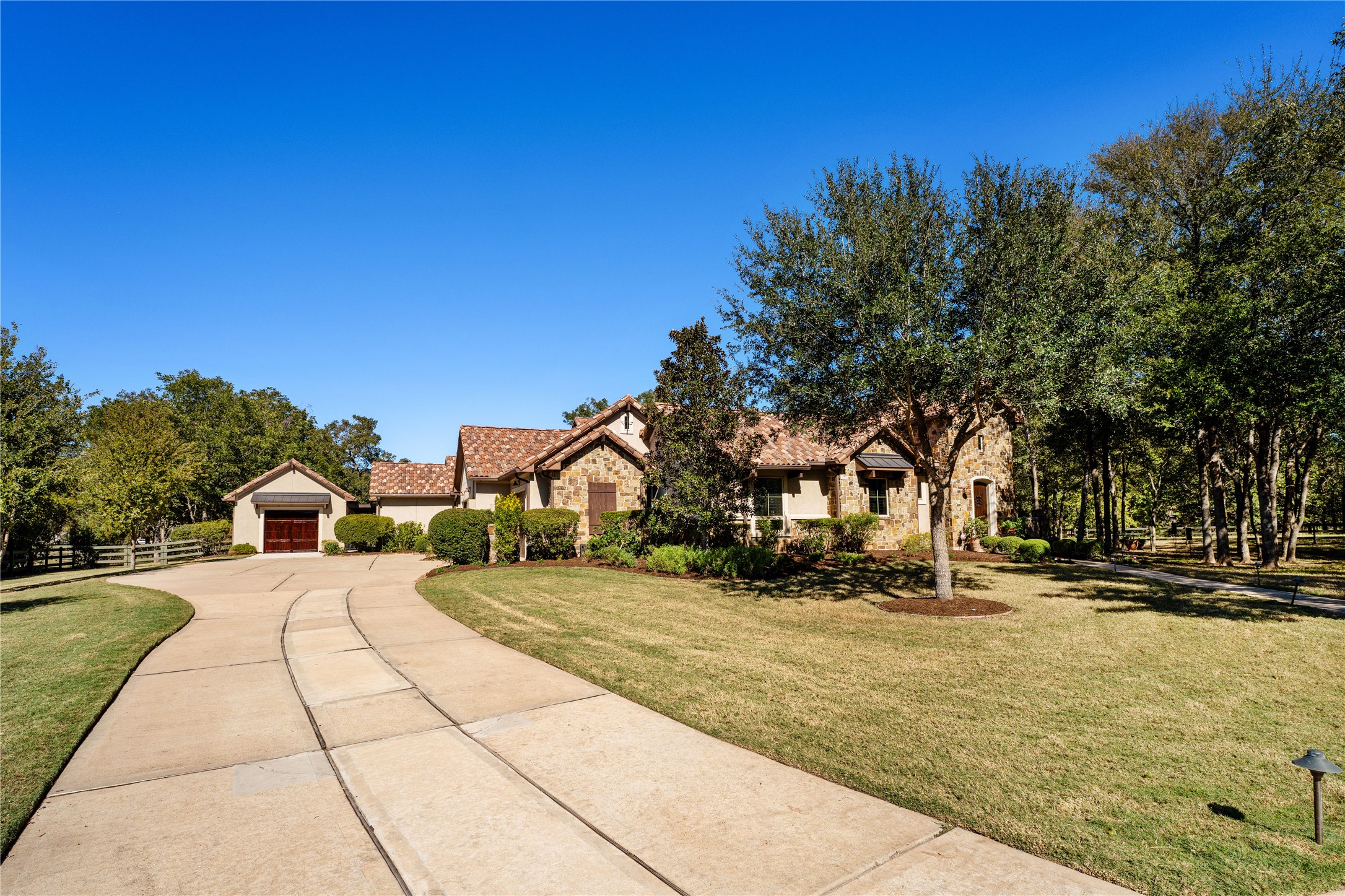 4727 Sugar Maple Court Fulshear, TX 77441 - Photo 49 of 50 This charming split bedroom layout, open floorplan Italian farmhouse on 1.4 acres is the perfect
peaceful place to call home. It has a stone and stucco exterior with a 50-year clay tile roof surrounded
by numerous mature trees and native landscaping.