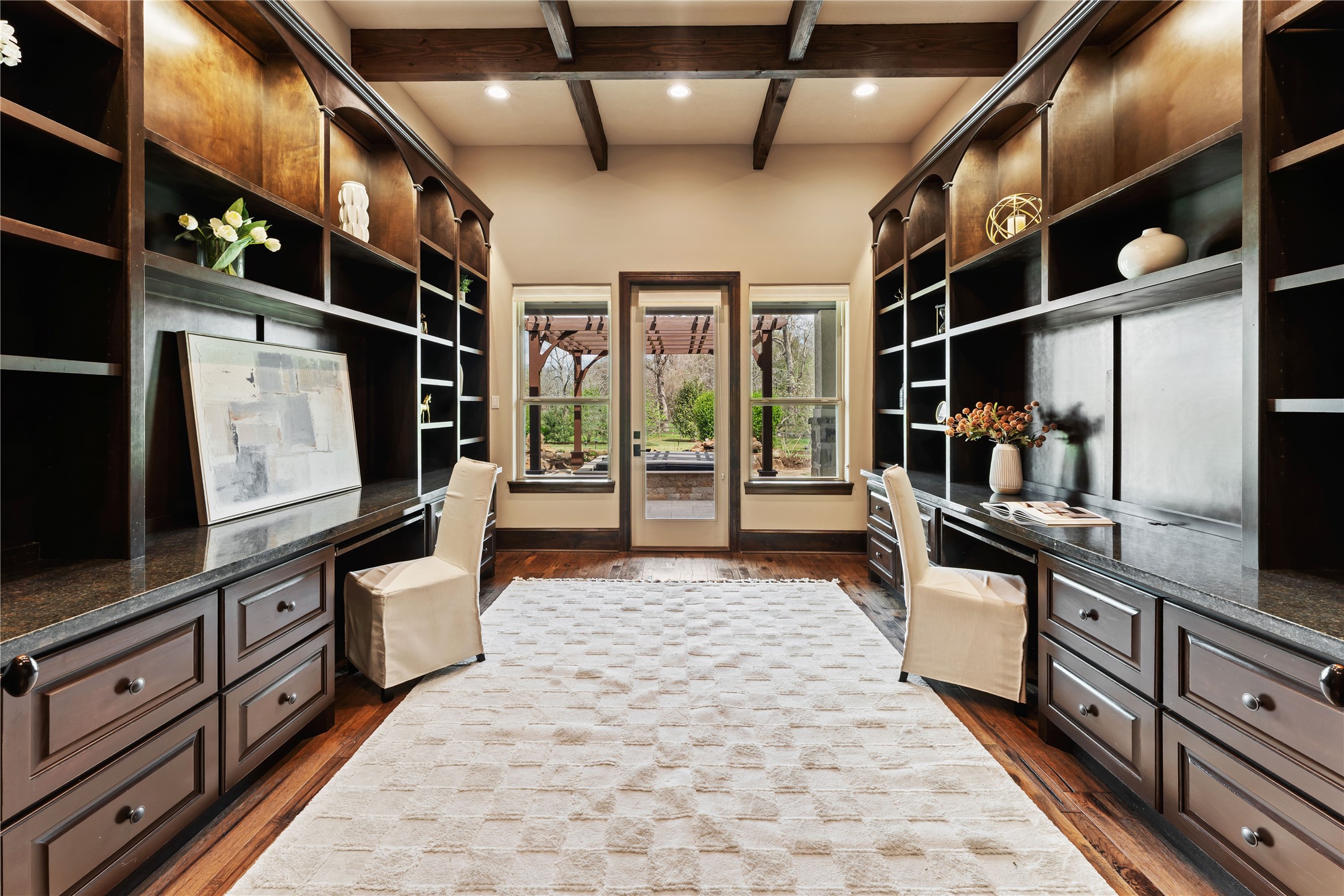 4727 Sugar Maple Court Fulshear, TX 77441 - Photo 19 of 50 An executive office with a view includes beautiful built-ins, solid wood cross hatch ceiling
beams, wood floor and two work areas. A dream for anyone who works from home.