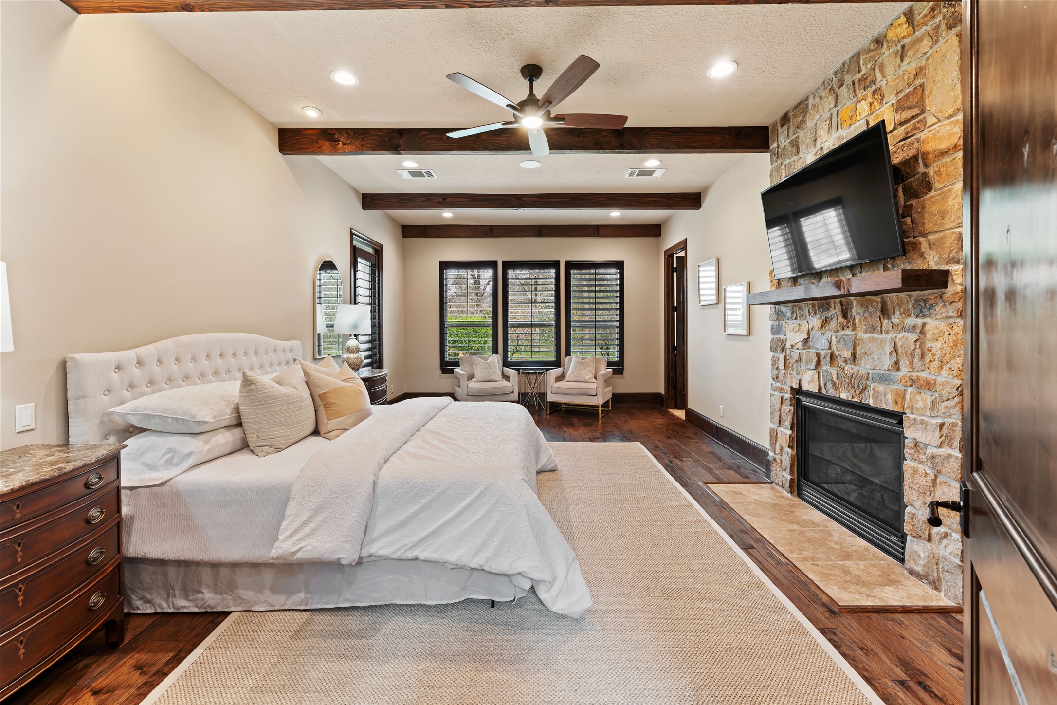 4727 Sugar Maple Court Fulshear, TX 77441 - Photo 23 of 50 a living room with furniture a fireplace and a flat screen tv
