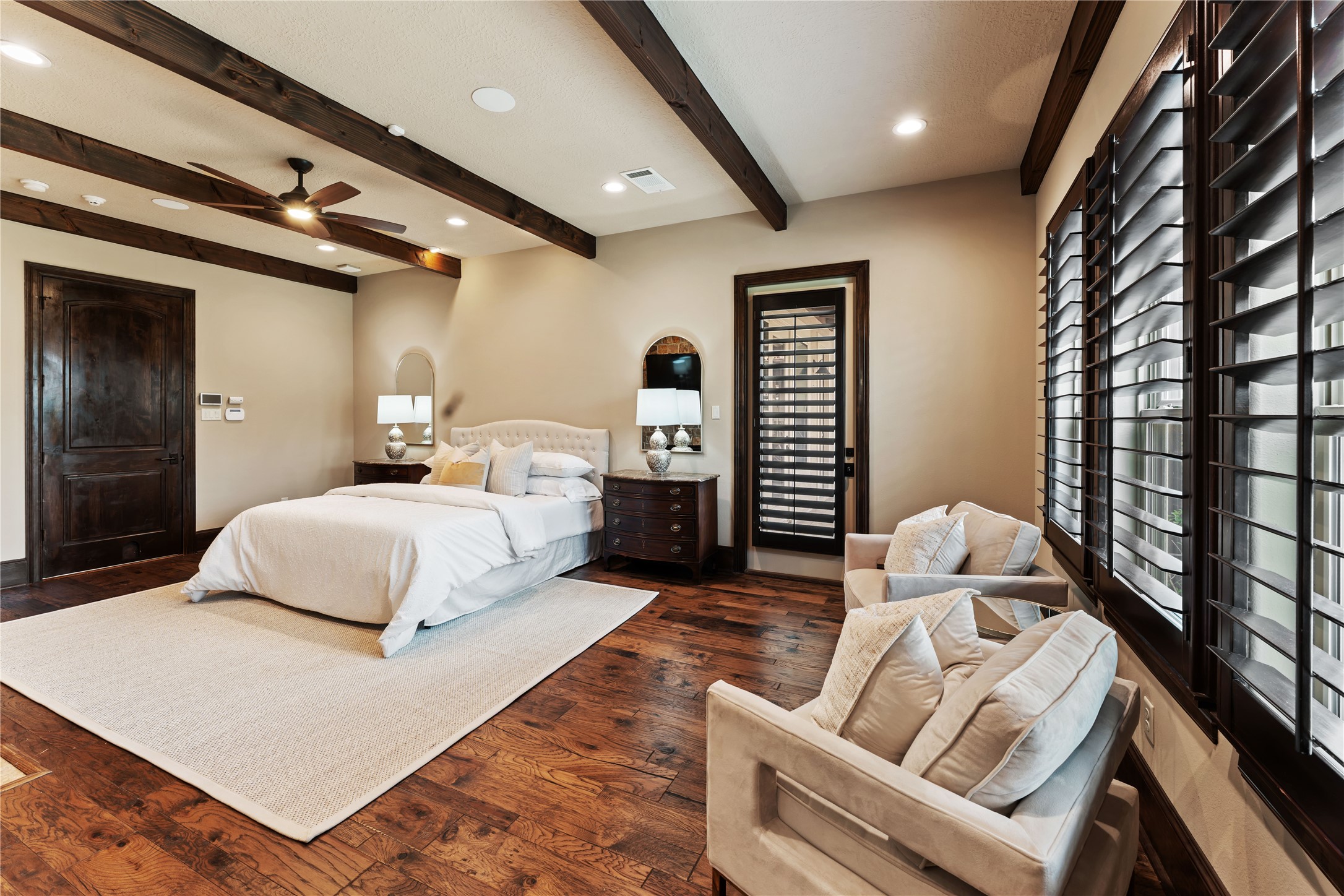 4727 Sugar Maple Court Fulshear, TX 77441 - Photo 24 of 50 The primary suite includes plantation wood shutters and an exterior door to the back outdoor
area and hot tub.