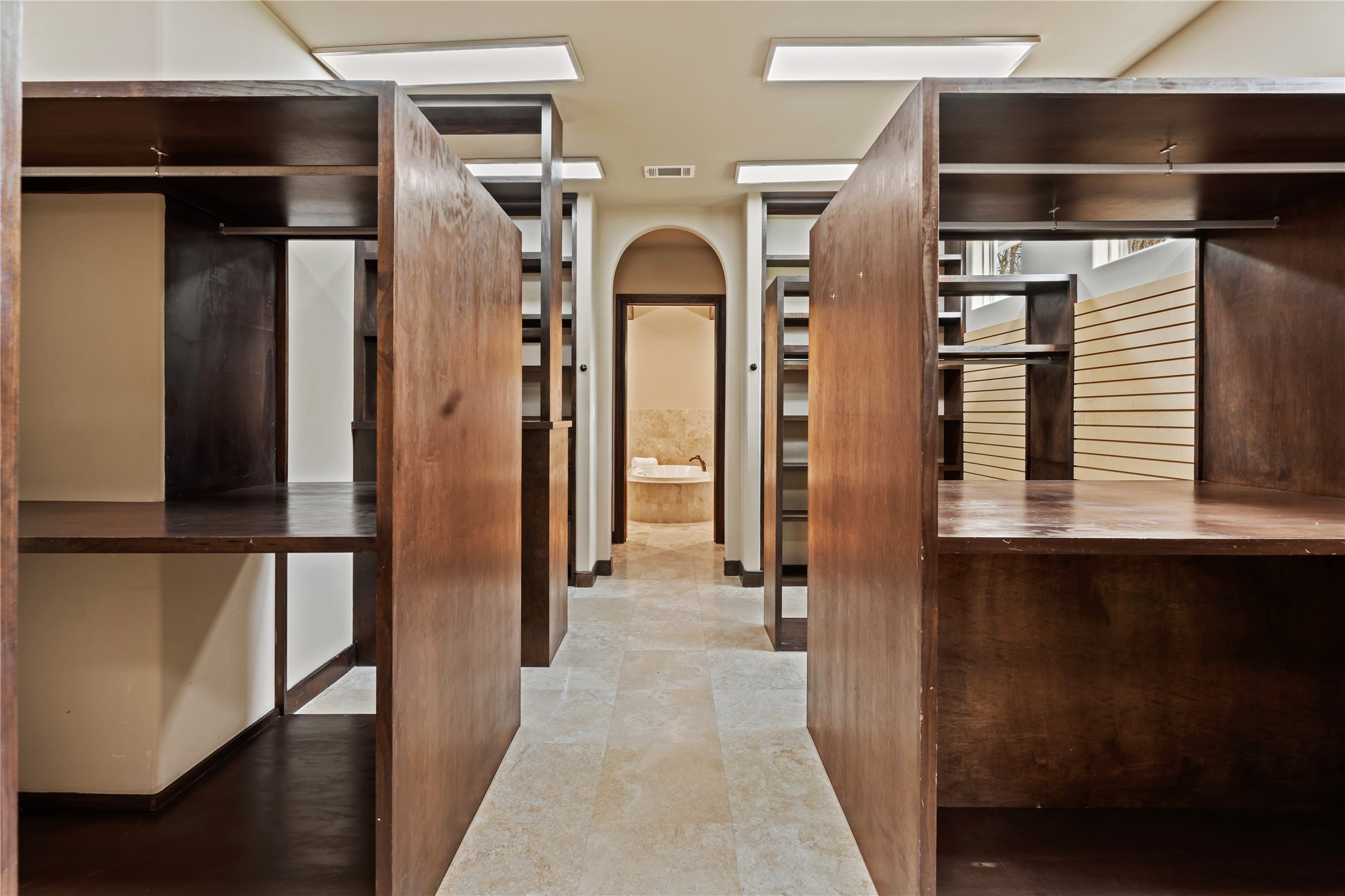 4727 Sugar Maple Court Fulshear, TX 77441 - Photo 27 of 50 Expansive primary closet with stained wood cabinetry.