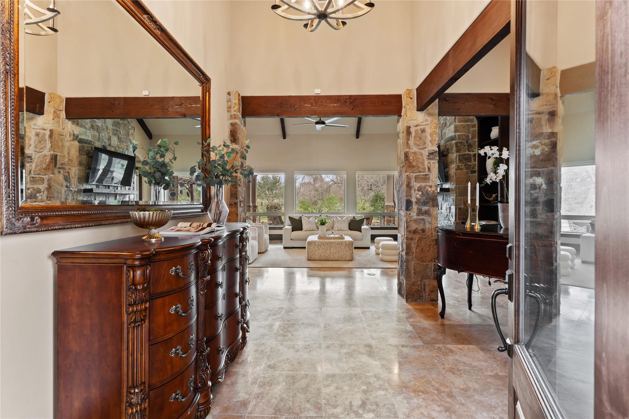 4727 Sugar Maple Court Fulshear, TX 77441 - Photo 4 of 50 Enter the foyer and immediately see a beautiful view of the back covered patio
area through a wall of windows that bring an abundance of natural light into the living area.