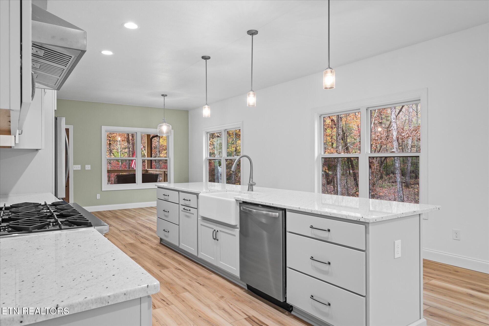 565 Grassland Road Crossville, TN 38572 - Photo 11 of 53 a kitchen with a stove a window and cabinets