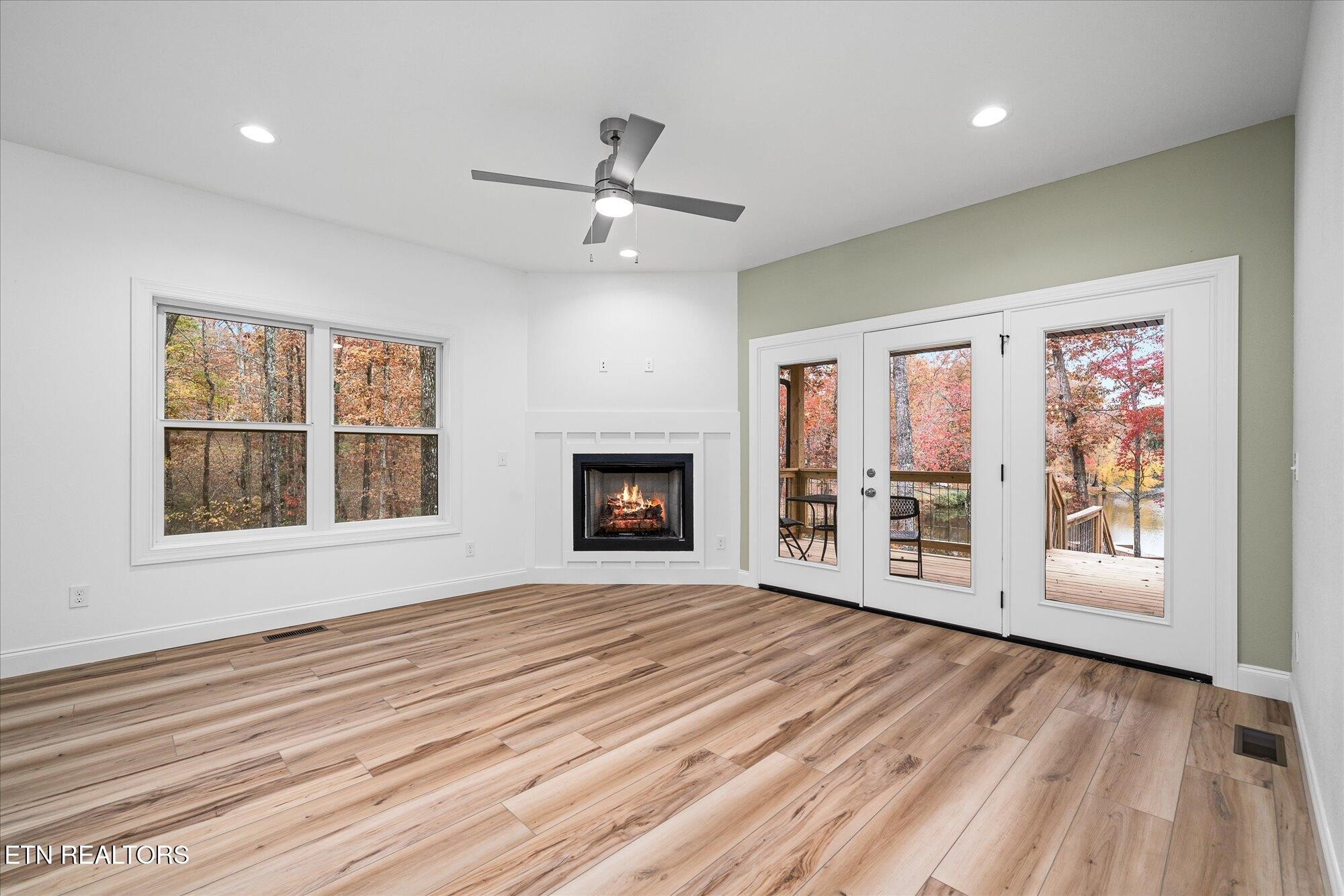 565 Grassland Road Crossville, TN 38572 - Photo 13 of 53 a view of an empty room with a window and wooden floor
