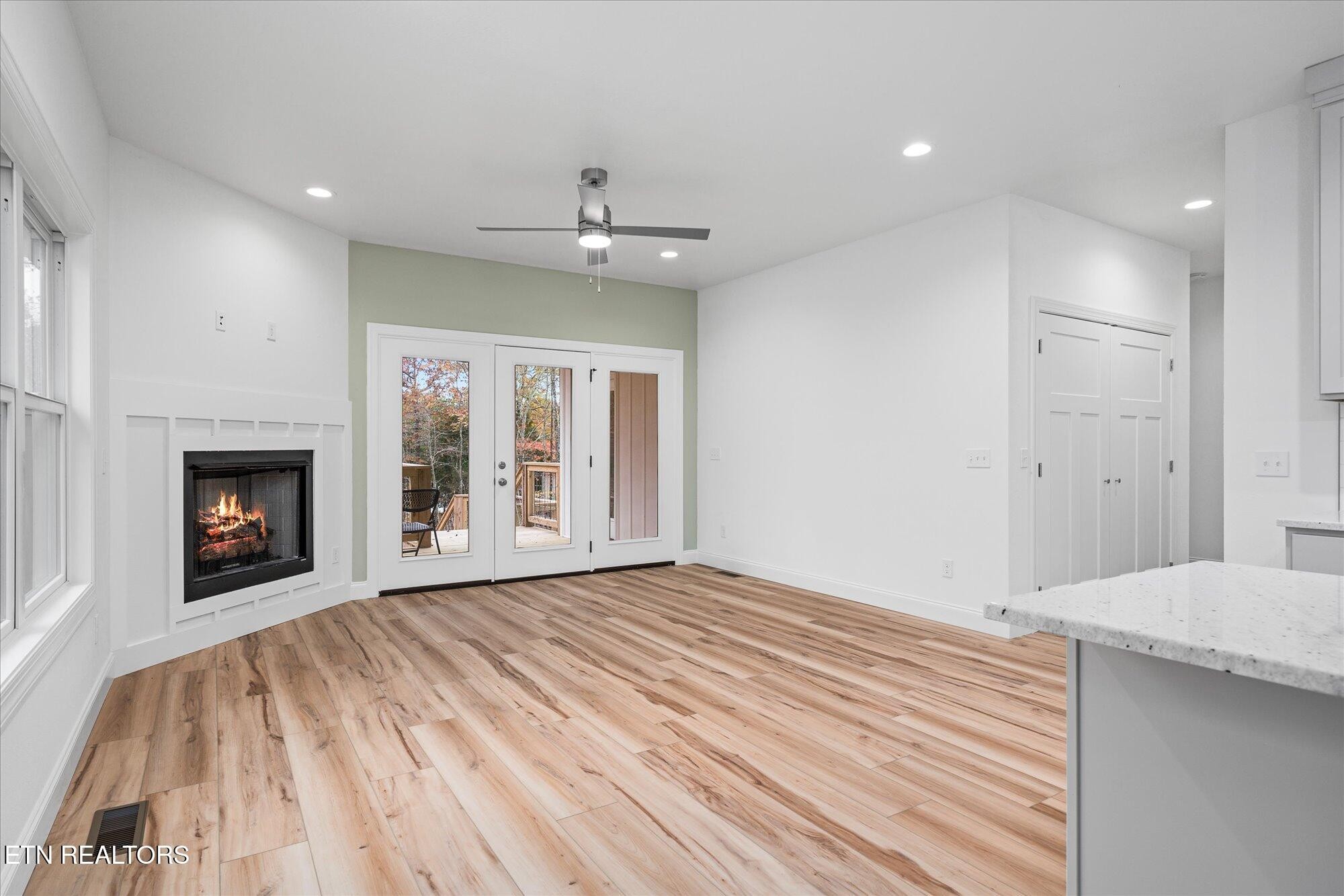 565 Grassland Road Crossville, TN 38572 - Photo 14 of 53 a view of an empty room with a fireplace and a window