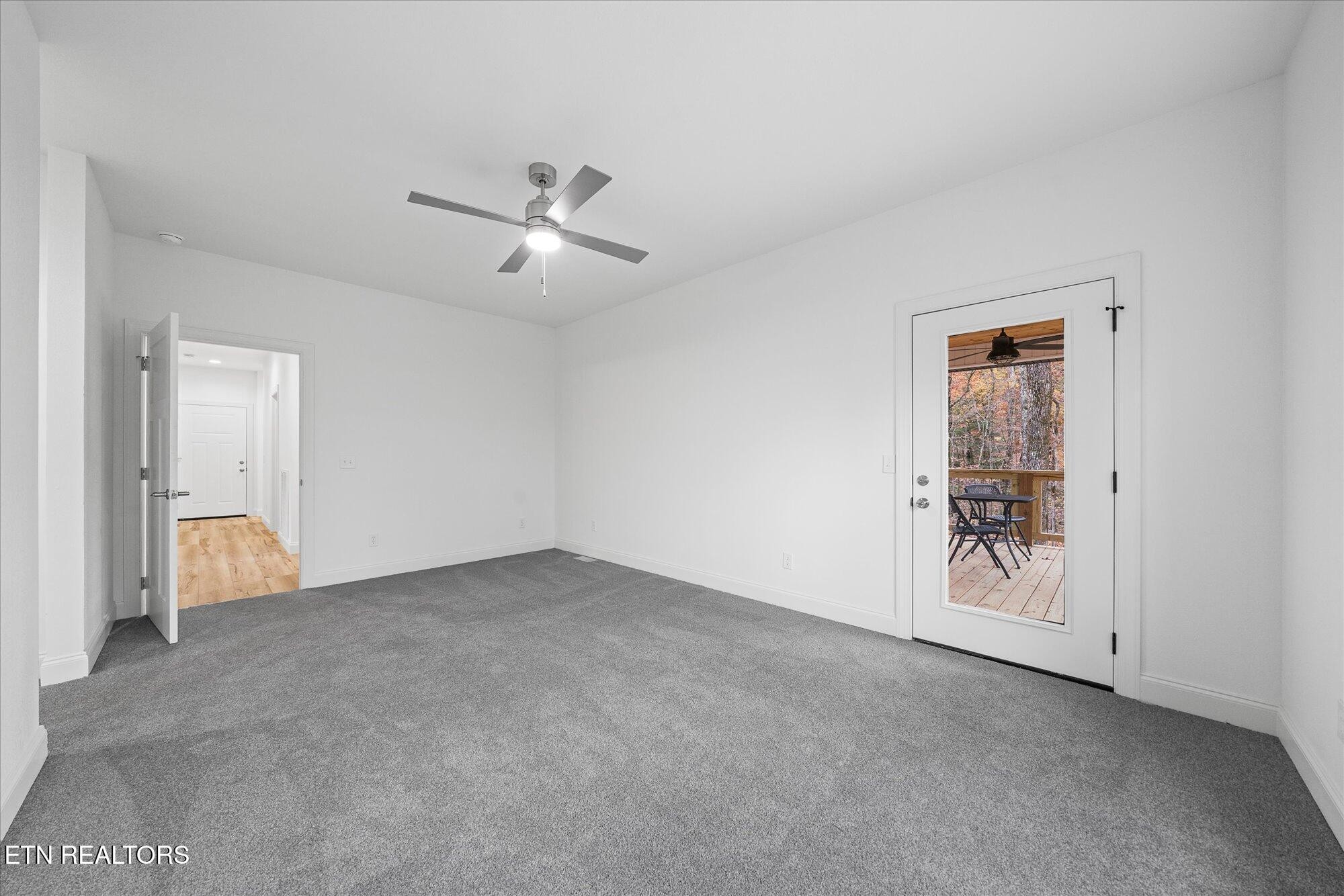 565 Grassland Road Crossville, TN 38572 - Photo 20 of 53 a view of an empty room and a ceiling fan