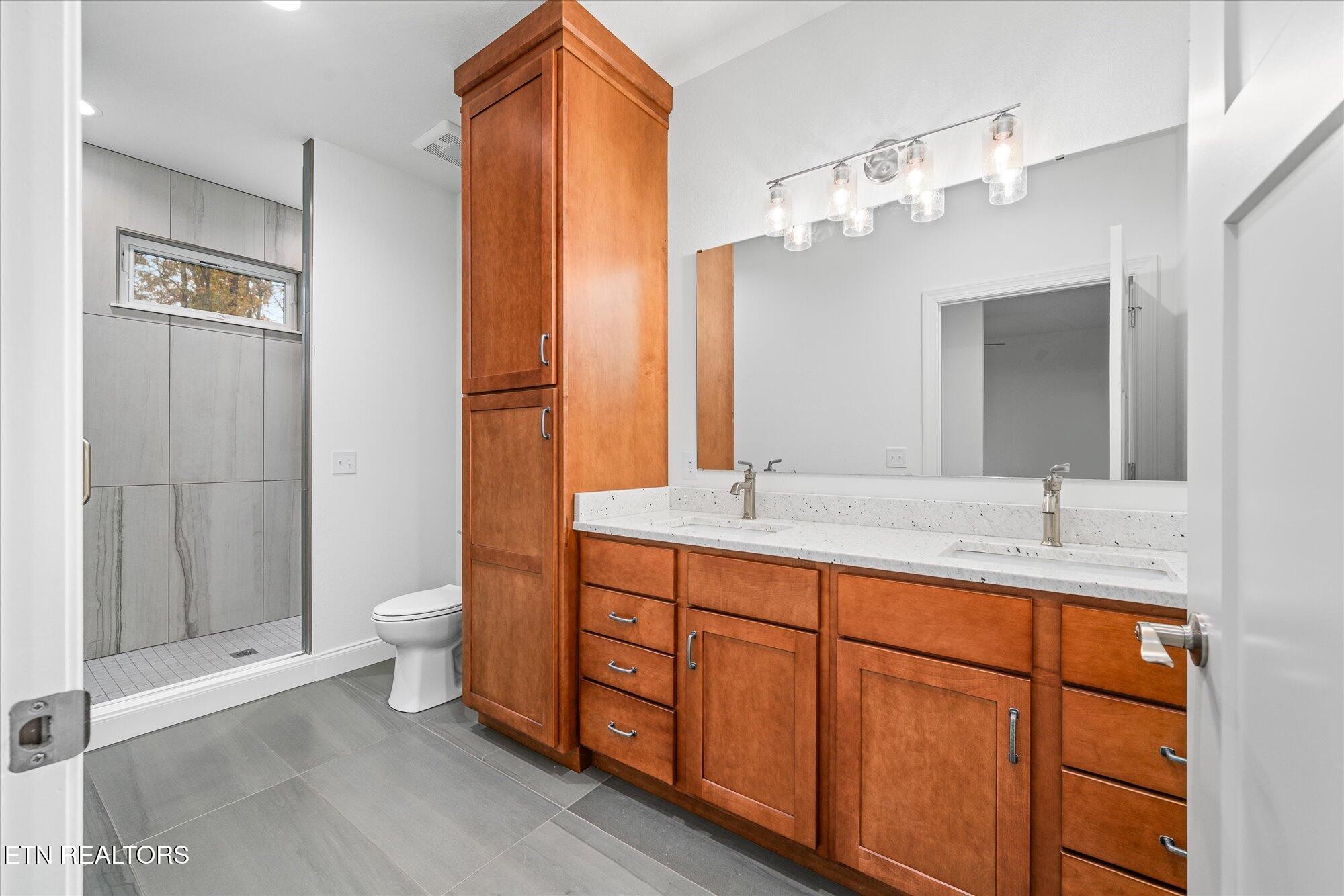 565 Grassland Road Crossville, TN 38572 - Photo 22 of 53 a bathroom with a double vanity sink mirror and toilet