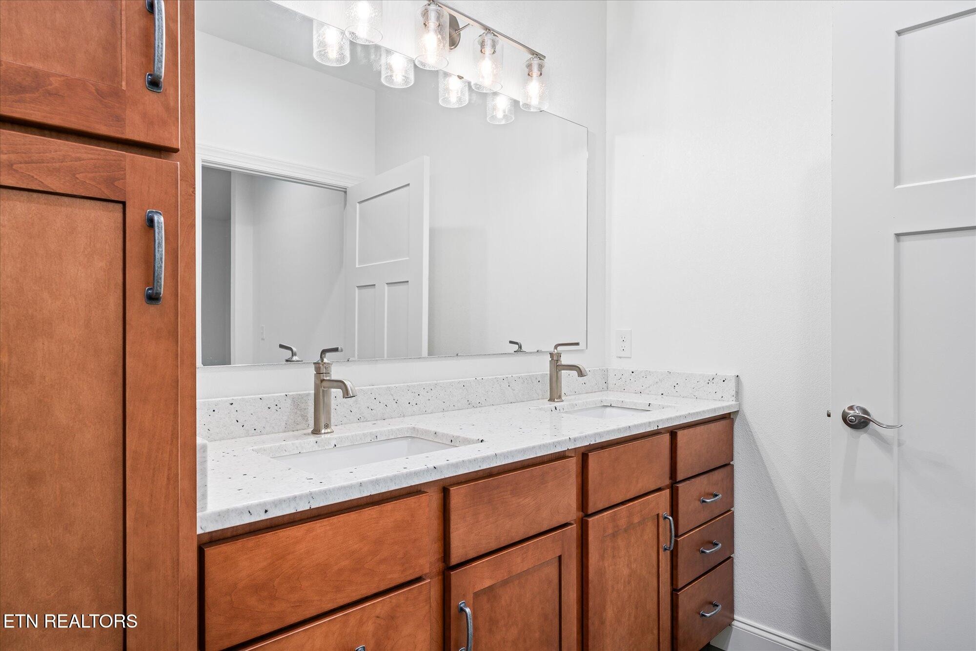 565 Grassland Road Crossville, TN 38572 - Photo 23 of 53 a bathroom with a granite countertop sink and a mirror