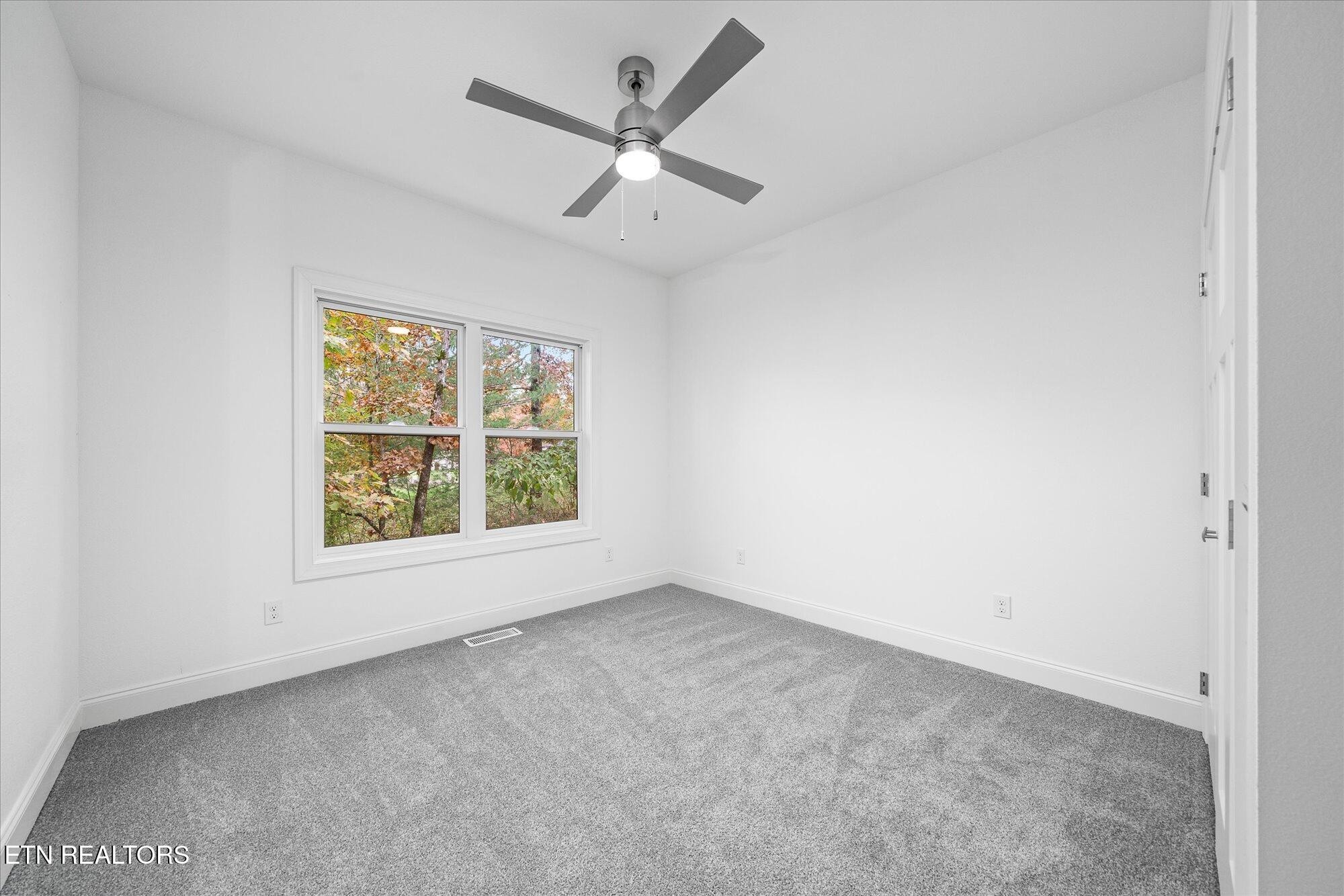565 Grassland Road Crossville, TN 38572 - Photo 31 of 53 an empty room with a window