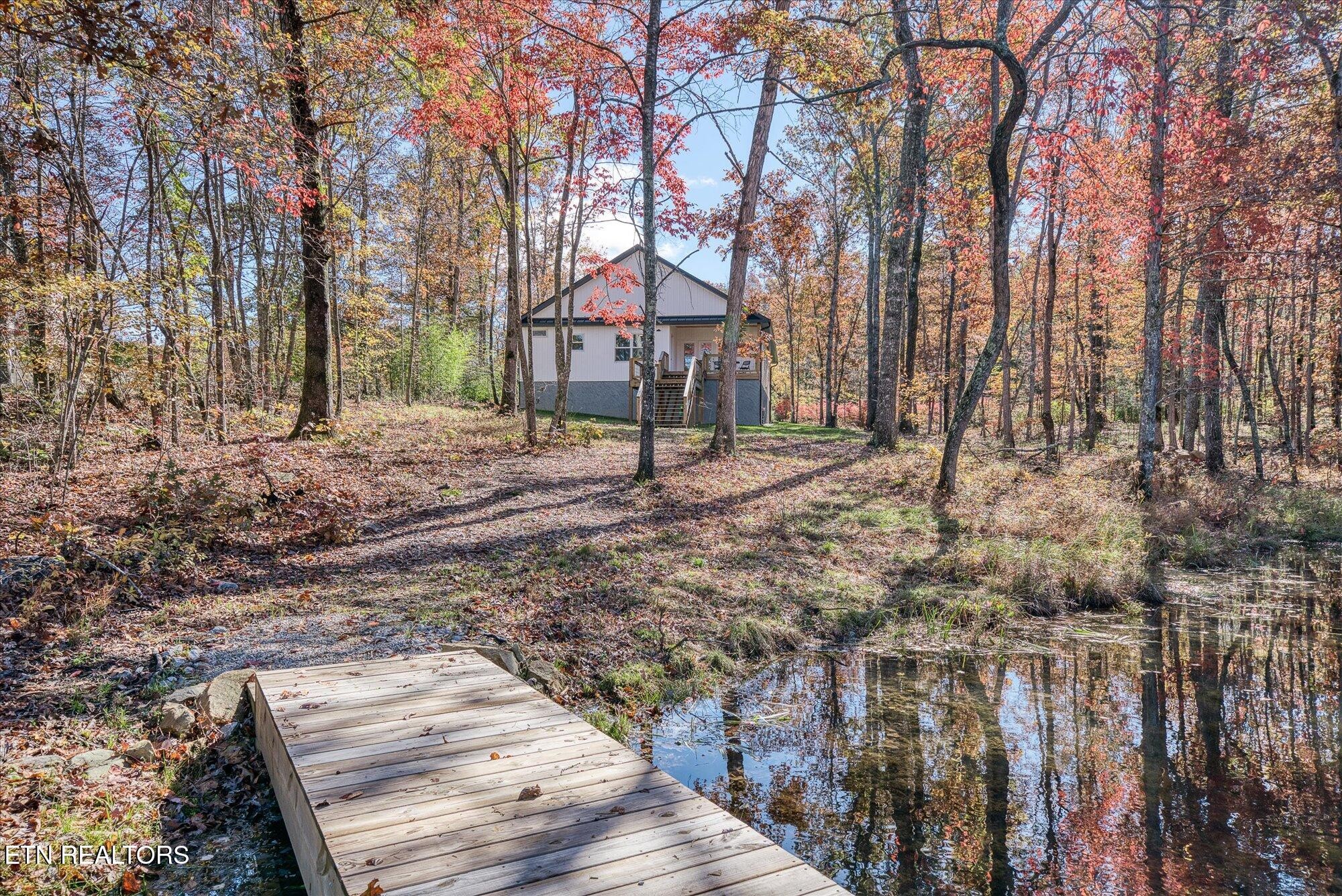 565 Grassland Road Crossville, TN 38572 - Photo 43 of 53 a wooden house with large trees