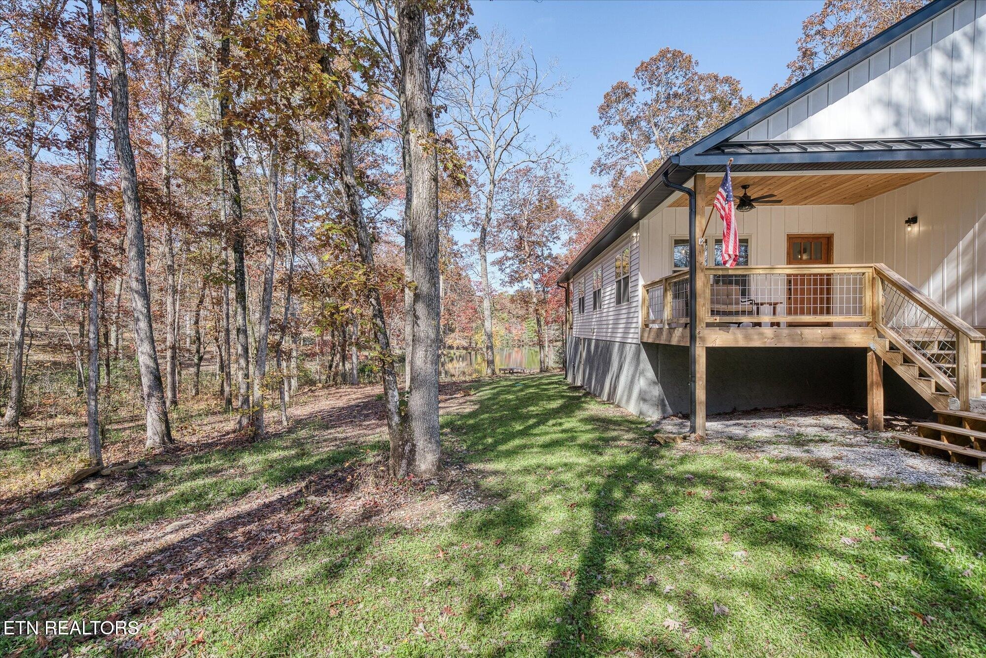 565 Grassland Road Crossville, TN 38572 - Photo 48 of 53 a view of house with backyard and trees