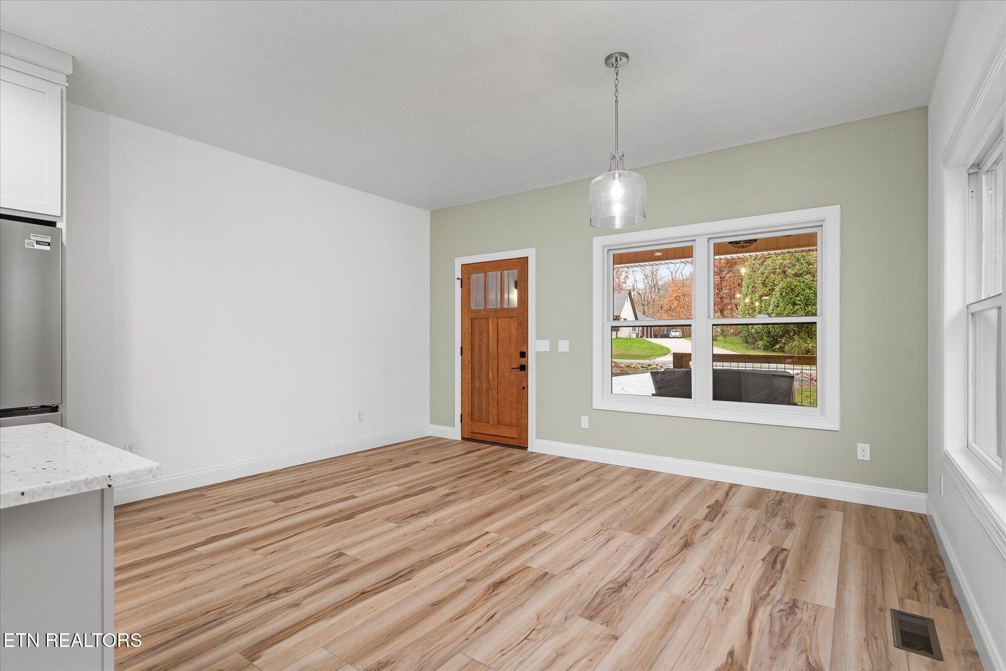 565 Grassland Road Crossville, TN 38572 - Photo 6 of 53 a view of an empty room with wooden floor and a window